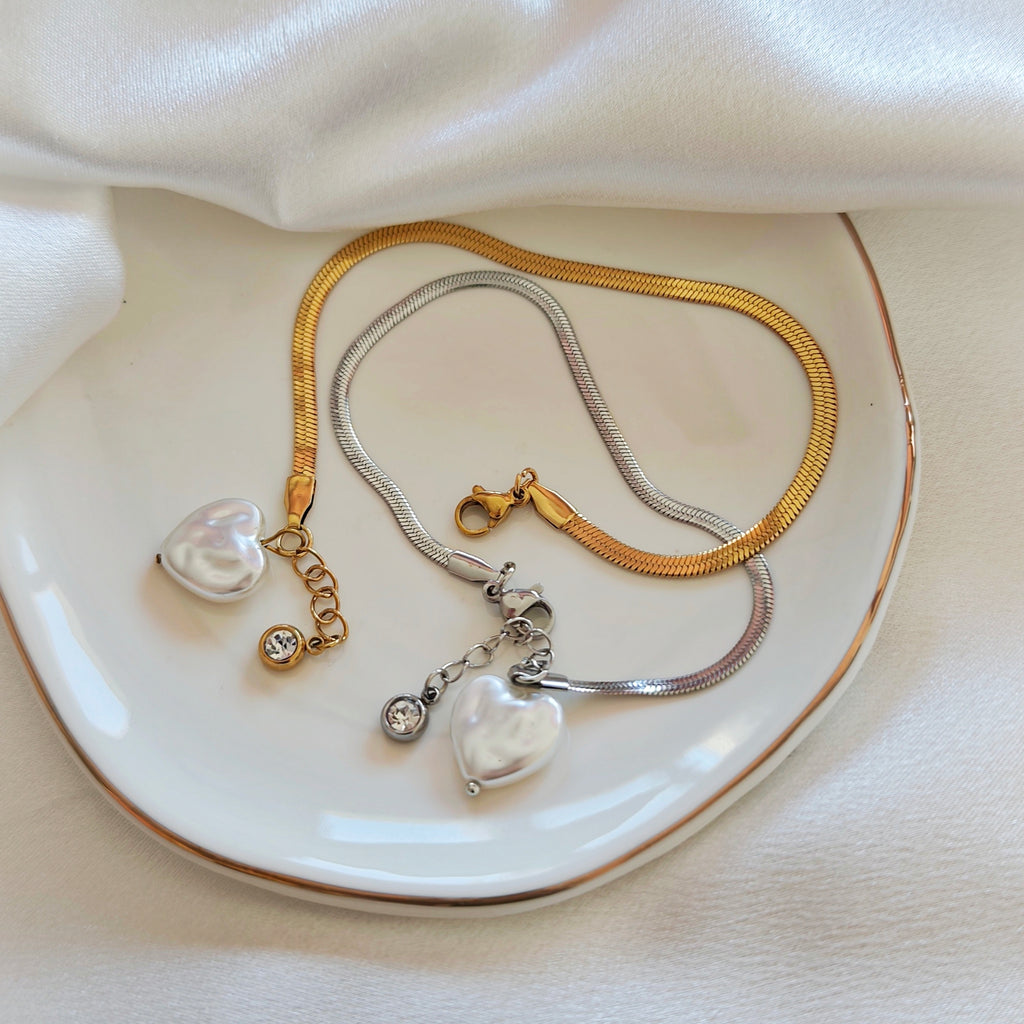 Gold and silver flat chain bracelets with pearlescent heart charms