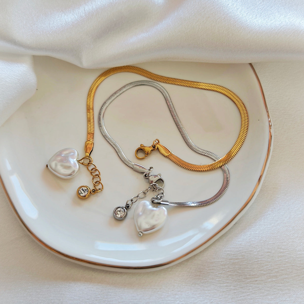 Gold and silver flat chain bracelets with pearlescent heart charms