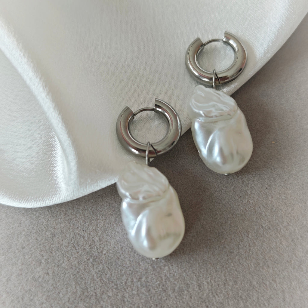 Silver-tone hoop earrings with elongated irregular white pearlescent drops
