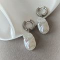 Silver-tone hoop earrings with elongated irregular white pearlescent drops