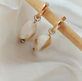 Gold-tone hoop earrings with amber-coloured oval acrylic beads
