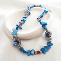 christisaccessories beaded shell necklace with blue chips, spiral shell focal beads, and gold-tone accents.