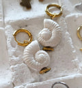 christisaccessories gold hoop earrings with pearlescent seashell charms for a coastal and elegant style.