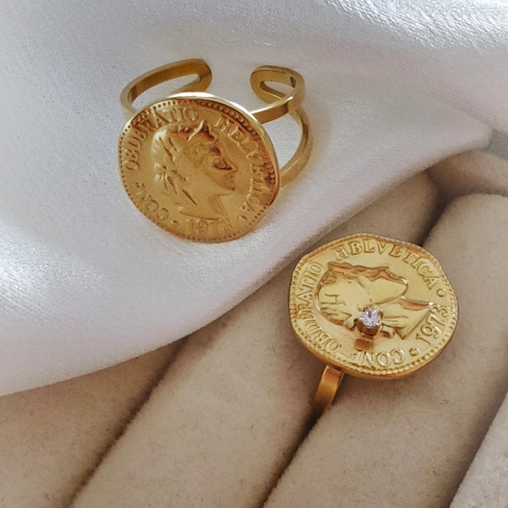 Two gold vintage coin rings, round and hexagonal with zircon