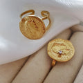 Two gold vintage coin rings, round and hexagonal with zircon