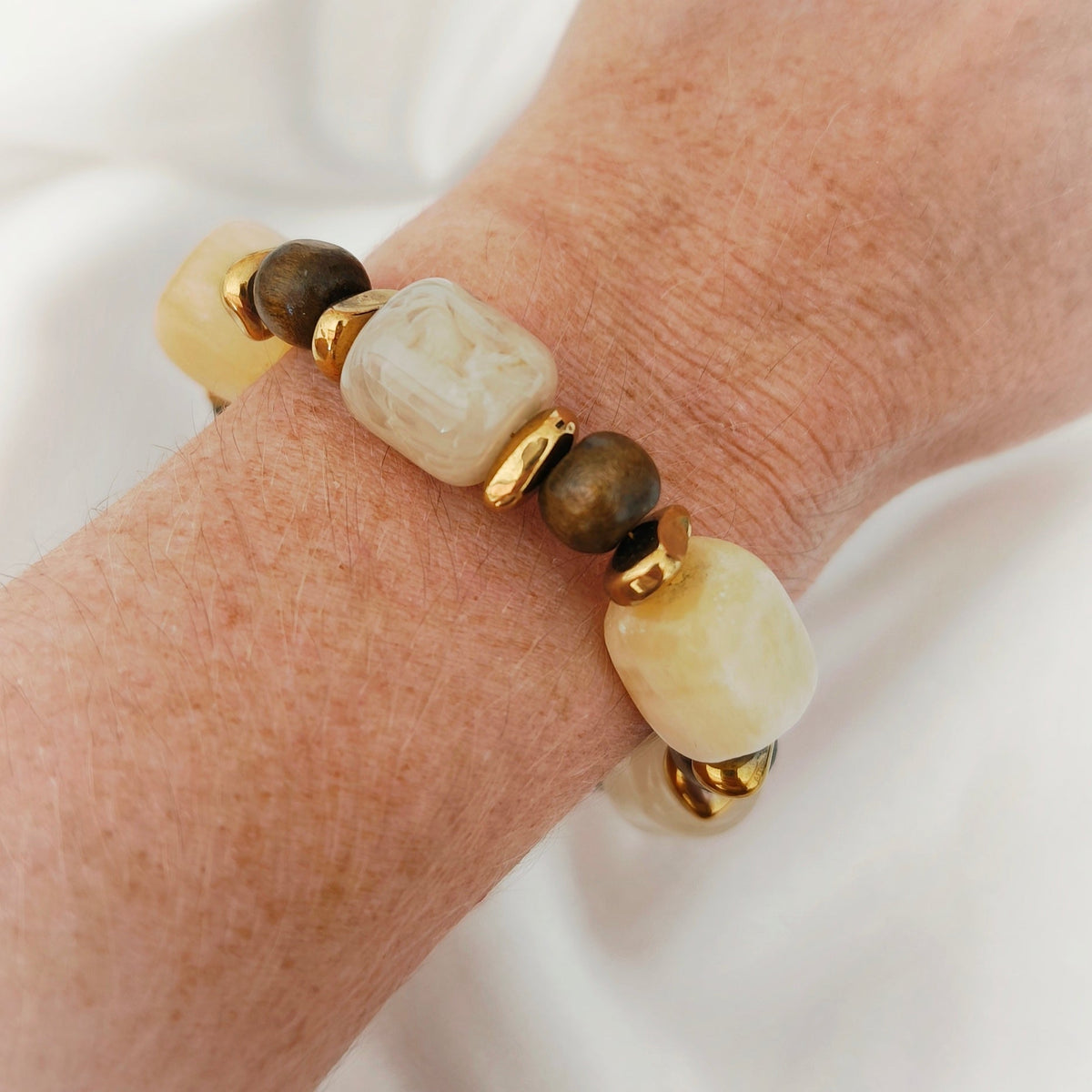 Earth Tones Bracelet with cream and brown beads and gold-tone chain on white background