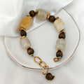 Earth Tones Bracelet with cream and brown beads worn on wrist