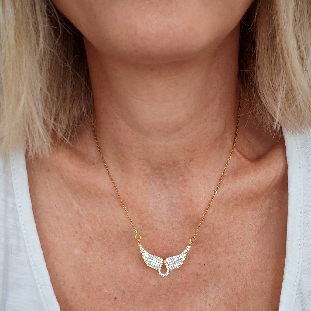 Gold wings necklace with crystals worn on neck